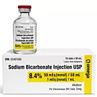High-resolution product photo featuring a 50 mL vial of Sodium Bicarbonate Injection USP with a red cap, placed on top of a white Omega-branded box. The box displays key information including concentration of 8.4%, dosage instructions, and is labeled for 