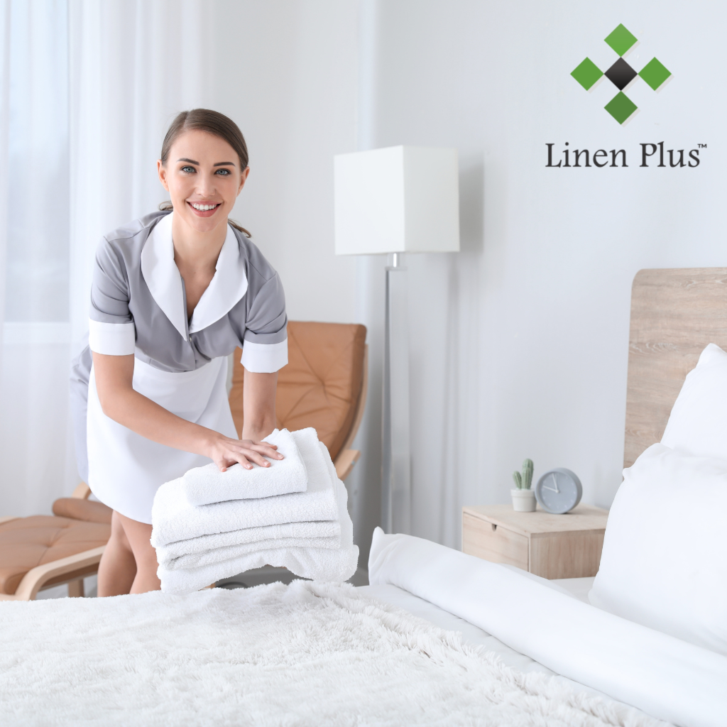 Luxury hotel room featuring high-quality white bed linens and bath towels from Linen Plus with neatly arranged amenities in the bathroom, highlighting the premium comfort and elegance offered by Linen Plus products for hotels, motels, and Airbnb hosts.